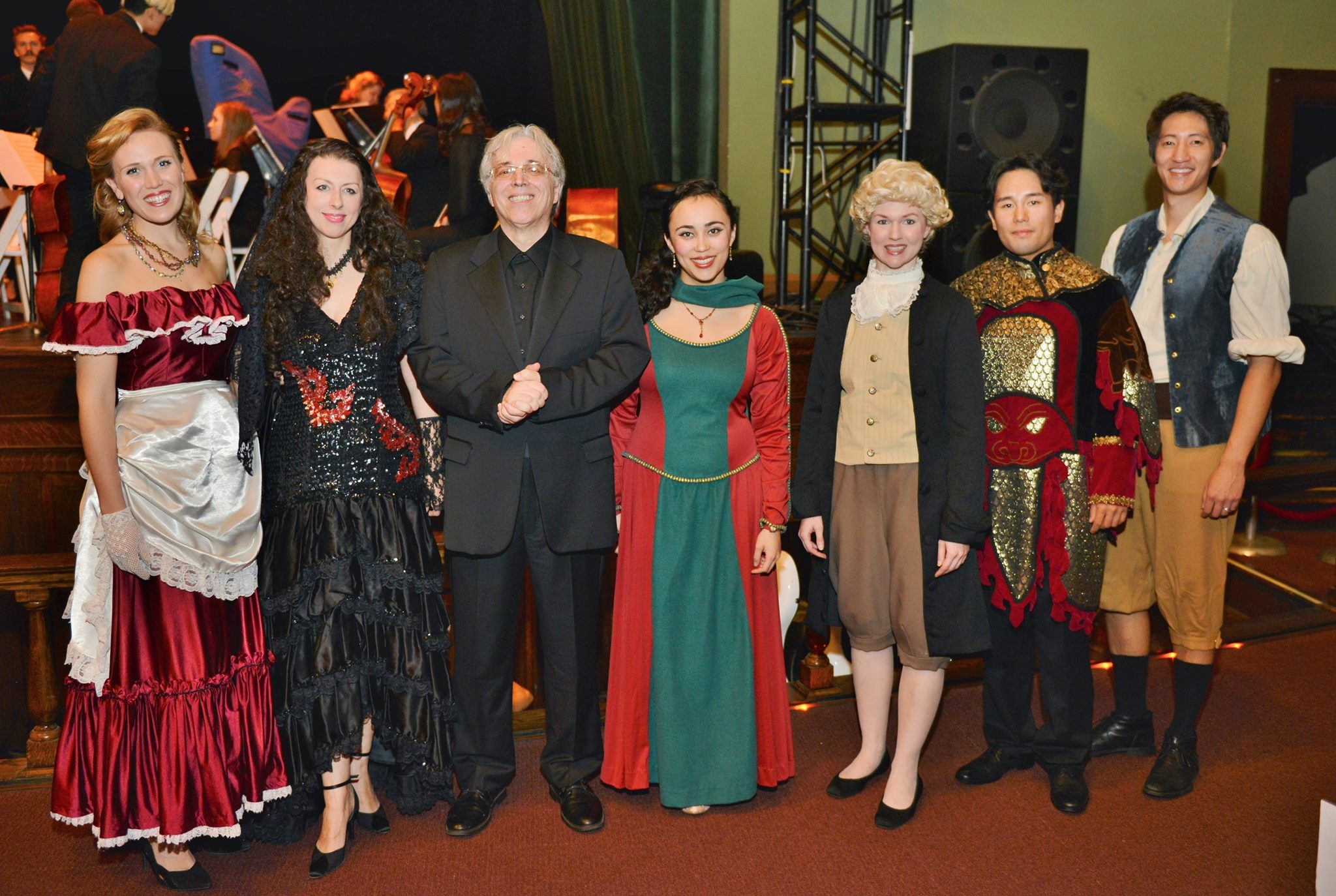 Maestro Aurelia with several opera singers in costume